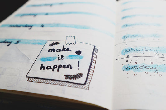 A planner with a not saying "make it happen!" to give motivation for long and short term goals.